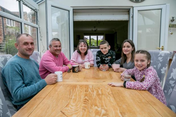 The Northern Echo: Nataliie Kucher, Nika 8, Artem 6 and Anton Cucer the Ukranian family now living near Bedale with sponsers Alison and Mark williams and dogs Belle and Bailey Picture: SARAH CALDECOTT