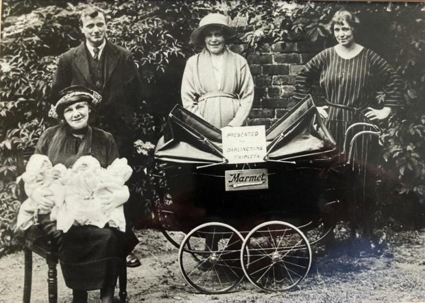 The Northern Echo: Annie, in the centre at the back, with Albert and the pram presented to her by Thornleys, who have stuck a "Darlington Triplets" notice inside it. Holding the three babies at the front is, we believe, the wife of the Darlington mayor (more