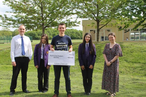 NEAS fundraising officer, Jon Appleton, receives the cheque from Emilie Jennings, left, and Lauren Ford. Also pictured, Head of RE Alex Marklew and RE teacher Jessica Duncan. Picture: Peter Barron