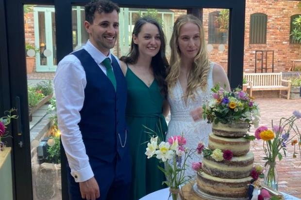 Jade, Tom, and Hannah with the precious wedding cake