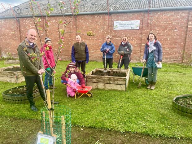 The Northern Echo: David Smith, left, and Helen Ball, right, Broadacres’ Sustainability Manager, with volunteers at the Applegarth Community Garden