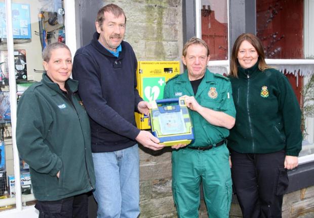 The Northern Echo: Nigel Mitchell, second from right, in 2013, with Gary Hutchinson, whose life was saved by one of the defibrillators. Picture: NORTHERN ECHO 