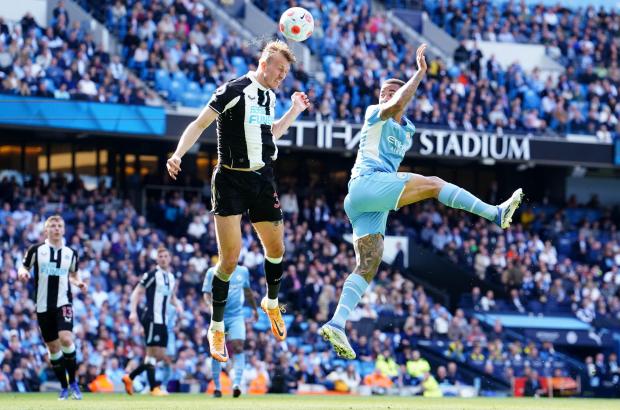 The Northern Echo: Newcastle United's Dan Burn (left) and Manchester City's Gabriel Jesus battle for the ball during the Premier League match at the Etihad Stadium, Manchester. Picture date: Sunday May 8, 2022.