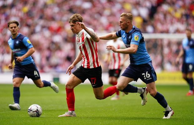 The Northern Echo: Sunderland's Dennis Cirkin (left) and Wycombe Wanderers' Jason McCarthy battle for the ball during the Sky Bet League One play-off final at Wembley Stadium, London. Picture date: Saturday May 21, 2022.