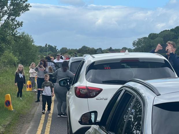 The Northern Echo: People getting out of cars while in traffic jams to watch The Red Arrows. Picture: JIM SCOTT