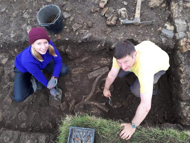 The Northern Echo: Community Archaeologist Jodie Hannis (left) and a local resident unearth a medieval window frame during a community excavation at Bishop Middleham. Photo credit: DigVentures