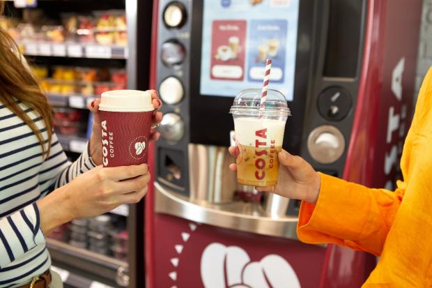 The Northern Echo: One person holding a hot drink (left) and another person holding a cold drink (right) in front of a new Costa Express machine (Costa Coffee)