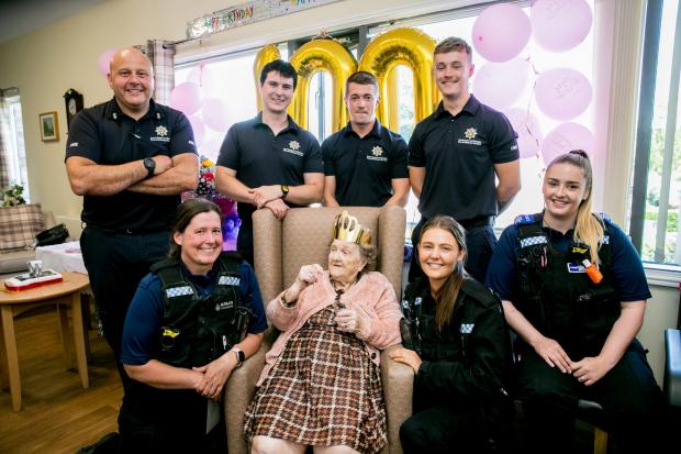 The Northern Echo: Louie Young is celebrating her 100th birthday at Appleton Lodge in Spennymoor, she is pictured with the local Fire crew and Police Officers that visit the home Picture: SARAH CALDECOTT