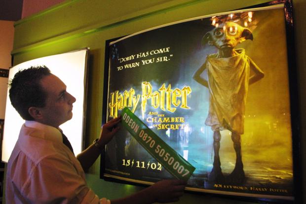 The Northern Echo: 2002: Assistant manager Karl Pharoah puts up backlit posters for the new Harry Potter film The Chamber of Secrets. Picture: ANDY LAMB
