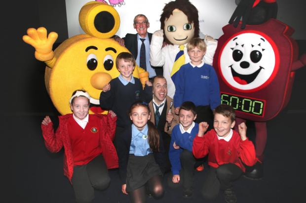 The Northern Echo: Schoolchildren meet the MegaMotion mascots at the launch event at the Odeon Cinema. With them are presenter David Cooper from Histrionics (acting group), centre and Coun David Lyonette, back, cabinet member for transport, Darlington Council. Picture: ANDY LAMB