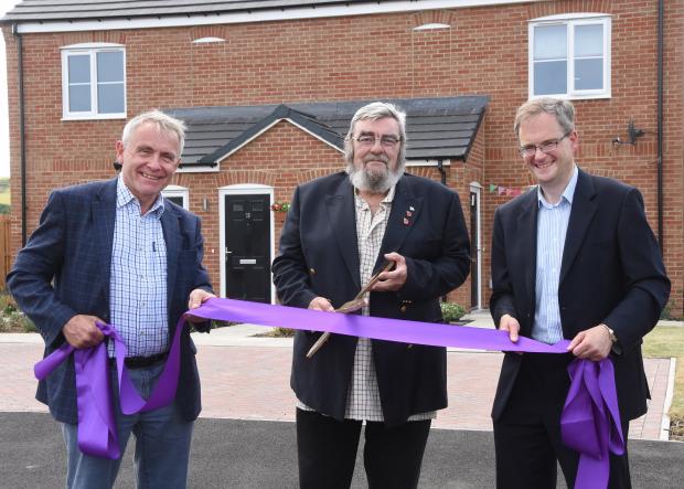 The Northern Echo: Robert Goodwill MP with Staithes Harbour Master Norman Fowler and Steve Secker YHA Chair, cutting the ribbon on the new homes