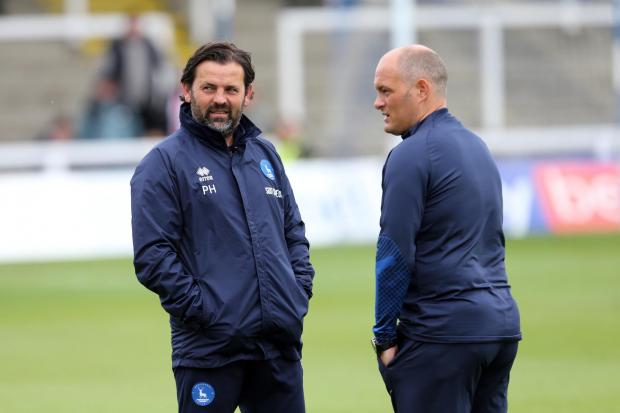 Pools manager Paul Hartley (left) in conversation with Sunderland boss Alex Neil (right)