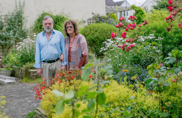 The Northern Echo: Pete and Cath Proud in their Blackwell garden which is open to the public tomorrow. Picture: SARAH CALDECOTT