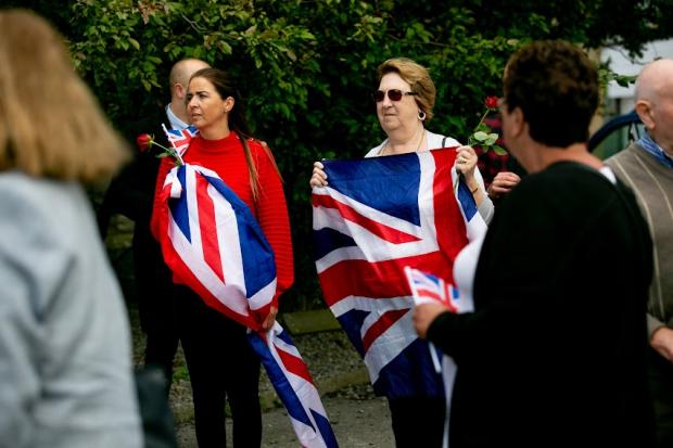 The Northern Echo: Mourners with union flags. Picture: SARAH CALDECOTT