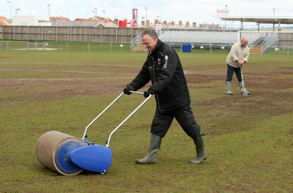 The Northern Echo: Darlington FC director Ian Wilkinson (centre) and club secretary Colin Galloway clear a waterlogged pitch at Heritage Park ahead of Darlington's Northern League clash with Team Northumbria. The Northern Echo: Darlington FC director Ian Wilkinson (centre) and club secretary Colin Galloway clear a waterlogged pitch at Heritage Park ahead of Darlington's Northern League clash with Team Northumbria.