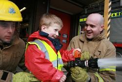 ADVENTURE DAY: Oliver Williams with firefighters Matt Stirland, left, and Tony Hardy