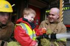 ADVENTURE DAY: Oliver Williams with firefighters Matt Stirland, left, and Tony Hardy