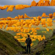 The saffron yellow sails of Hush in upper Teesdale, with the full majesty of the dale behind. Picture: SARAH CALDECOTT