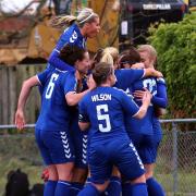 Durham Women's players celebrate a goal - the club are currently top of the Women's Championship table