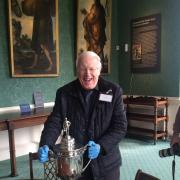 FOOTBALL: Chairman of the Durham Amateur Football Trust, Keith Belton with the Amateur Cup won many times by his beloved Bishop Auckland. He is holding the cup in Auckland Castle, Bishop Auckland