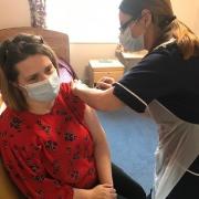 Staff member Emma Saunders receives a welcome dose of Covid vaccine at Woodhorn Park Care Home