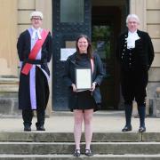 Jemma Clark, commended for helping road accident victims, by Judge James Adkin, left, and High Sheriff, Robert Harle  Picture: SARAH CALDECOTT