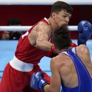 Pat McCormack, of Great Britain (left), lands a punch to Belarus' Aliaksandr Radzionau during their welterweight preliminary bout at the Tokyo Olympics (Picture: AP Photo/ Frank Franklin II)