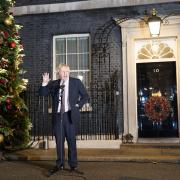 Boris Johnson speaking outside a festive Number 10 Downing Street. Credit: PA