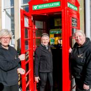 Julie Earrington, Beryl Anderson and Clair McGregor from Angel Trust with the defibrillator they have installed in the old phone box in Bishop Auckland Market Place Picture: SARAH CALDECOTT.
