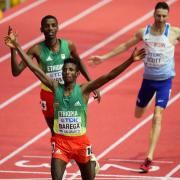 Marc Scott (right) crosses the line to win bronze at the World Indoors (Picture: AP Photo/Petr David Josek)