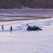 A motorist was later rescued from a car stranded out at sea by onlookers. Picture: PAUL KENT