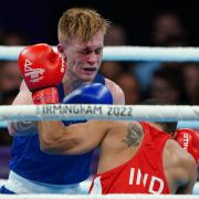 Kiaran MacDonald (blue) tries to fight back against India's Amit Panghal in the men's flyweight final at the Commonwealth Games. Picture: PETER BYRNE/PA WIRE