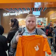 Customer service worker 'Mitch' with his free goodie-bag awarded as one of the first 50 in the queue at the opening of the new Popeyes restaurant at the Metrocentre today 
                                                             Picture: DANIEL