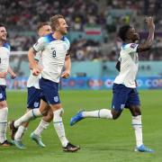 England's Bukayo Saka (right) celebrates scoring their side's fourth goal of the game during the FIFA World Cup Group B match at the Khalifa International Stadium in Doha, Qatar