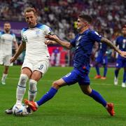 Harry Kane challenges for the ball with Christian Pulisic during England's goalless draw with the US at the World Cup