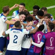England forward Marcus Rashford is swamped by his team-mates after opening the scoring in last night’s World Cup victory over Wales. Picture: MIKE EGERTON/PA WIRE.