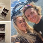 Cam Shaw with his girlfriend Ellyn in Sydney with pictures of the baby scan photo and a specially made baby grow