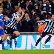 Dan Burn wheels away in celebration after scoring Newcastle's opening goal in their 2-0 win over Leicester