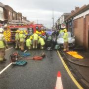 Dramatic scenes have shown a trapped driver being rescued by emergency services on a North East road as three people are taken to hospital Credit: TWFRS