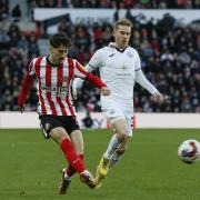 Sunderland defender Trai Hume plays a forward pass during his side's 3-1 home defeat to Swansea City at the Stadium of Light at the weekend