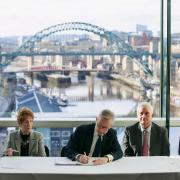 Michael Gove signs the devolution deal at the Baltic Centre in Newcastle.