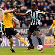 Alexander Isak holds off Max Kilman during Newcastle's win over Wolves