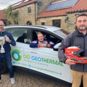 Dominic in a Go Geothermal electric car with, left, Sean Sowden, director of Go Geothermal, and, right, Mark Pearson, Go Geothermal business development manager