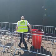 Stewards swiftly clear up waste outside the Stadium of Light.