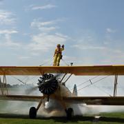 Nancy Spencer pictured strapped to the biplane.