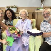 102-yr-old Joan Brown celebrates her birthday with Activities Coordinator Fran Tagg, Home Manager Marinda Aydinalp and her son John Dixon