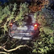 Suspected burglars crash through hedge after car chase