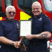 John Pate is pictured receiving a certificate from Chief Fire Officer Chris Lowther at TWFRS Service Headquarters in Washington.