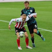 Alex Pritchard holds off his opponent during Sunderland's Carabao Cup defeat to Crewe
