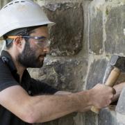 Apprentice Stonemason Jed Williams working on the Monks Garden Wall at Durham Cathedral